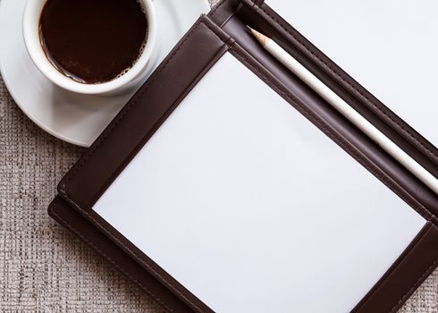 blank white notebook, pen and cup of coffee