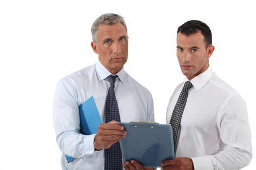 Two concerned businessmen stood with clip board