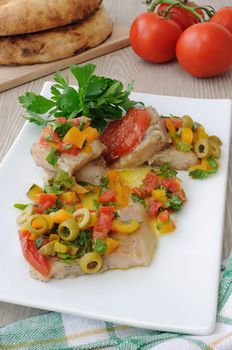 Pieces of fish steamed vegetables under