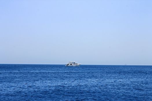 White ship moving by the red sea