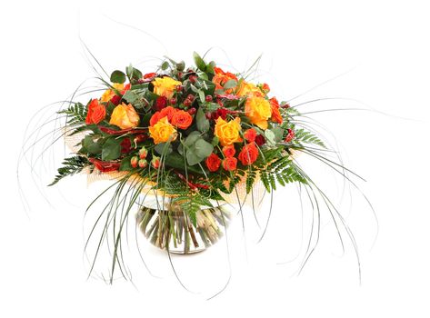 Flower arrangement of orange roses, hypericum and fern. Floral composition in a transparent glass vase. Isolated on white.