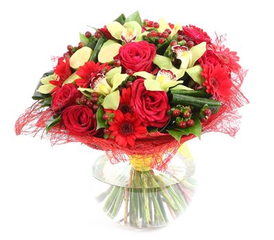 Flower arrangement in glass, transparent vase: red roses, orchids, red gerbera daisies. Isolated on white background. Floristic composition, design a bouquet, floral arrangement. 