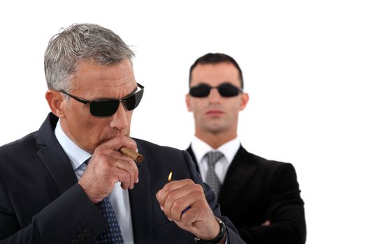 Wealthy businessman smoking cigar