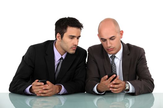 Businessmen comparing phones