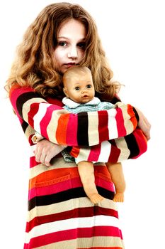 Lonely Abandoned Child Hugging Doll in studio over white.