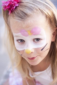 A girl with face painted for a party or carnival