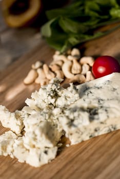 Close up shot of Roquefort cheese in a wooden plate