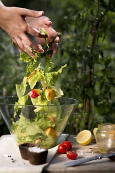 Salad preparation on a traditional wooden table outdoors