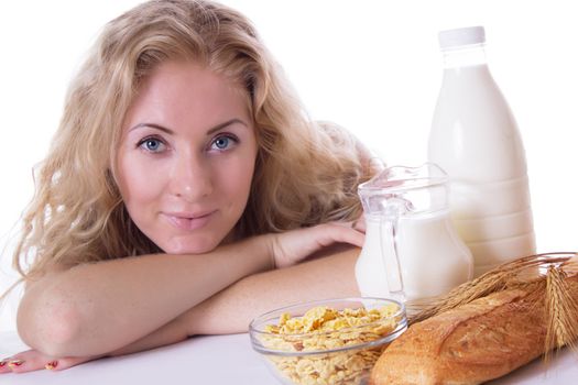 Pretty woman with corn flakes and milk isolated on white