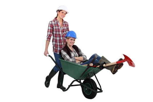 Two women with wheelbarrow