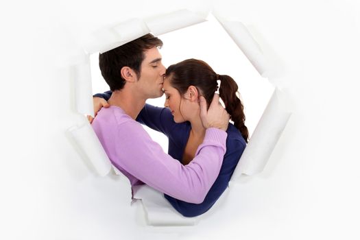 Man kissing girlfriend on forehead