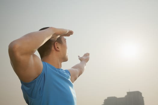 Young Muscular Man Stretching