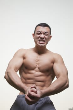 Muscular Man Growling and Flexing Shirtless
