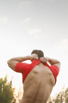 Muscular Man Taking Off His Shirt
