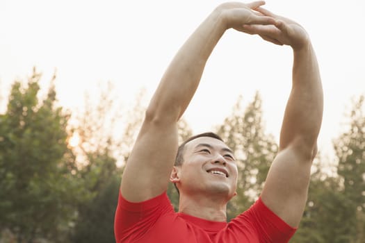 Muscular Man Stretching