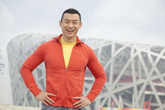Portrait of smiling young athletic man in park, Beijing 