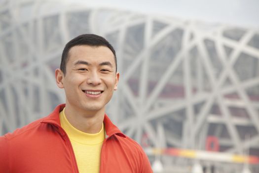 Portrait of smiling young man in park, Beijing, close-up 