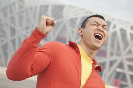 Determined young man with fist in the air, Beijing 