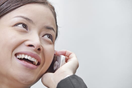 Close Up of Smiling Businesswoman on the Phone in Beijing