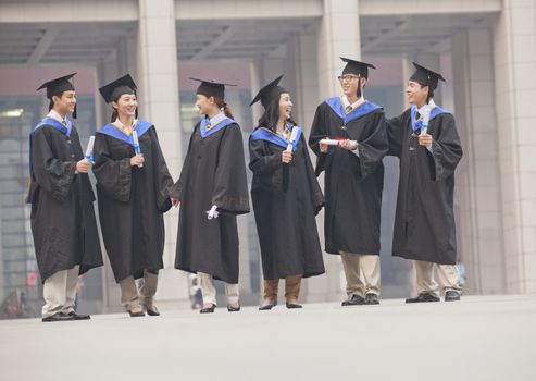 Group of Graduate Students Standing with Diplomas