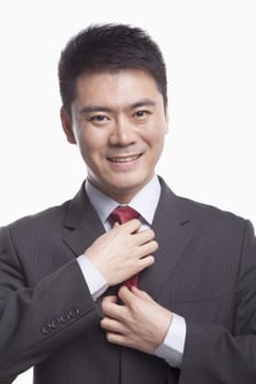 Businessman Adjusting His Tie