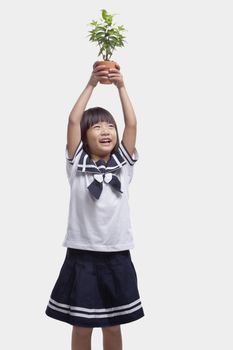 Girl Holding Potted Plant Over Her Head