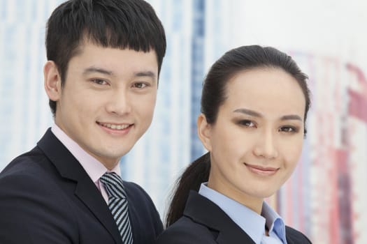 Close-up of young business man and woman, portrait