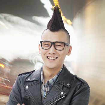 Young man with punk Mohawk smiling