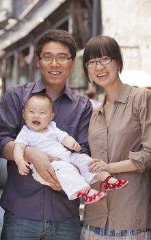 Family portrait, father is holding the baby