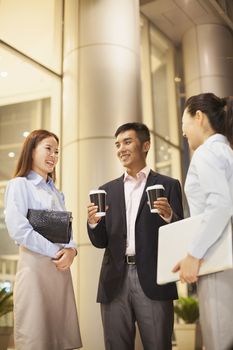 three business people talking outside the office