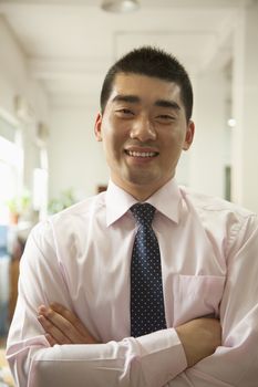 Young man smiling in the office, portrait