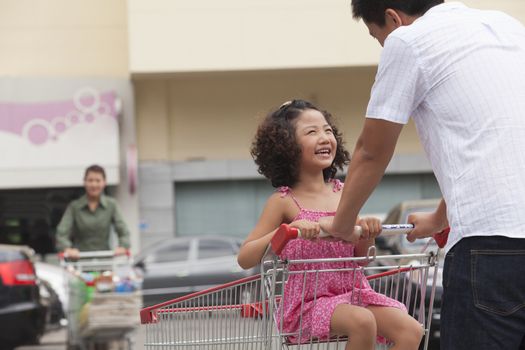 Daughter and father with shopping cart