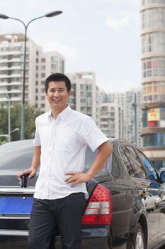 Man standing next to his car