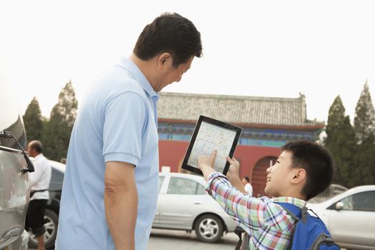 Father and son with digital tablet