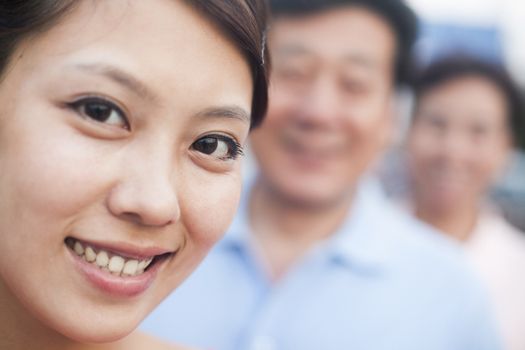 Woman smiling with her parents, portrait