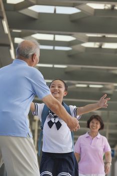 Granddaughter running towards her grandfather