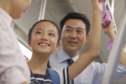 Family smiling in the subway