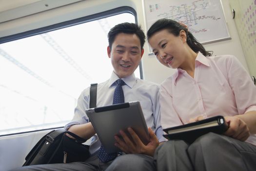 business couple working in the subway