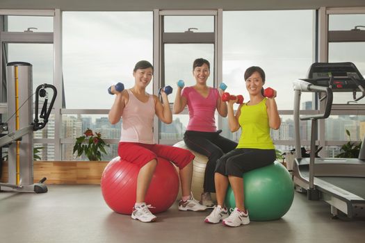 mature women exercising with fitness ball