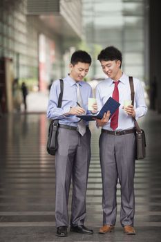 Two young businessmen working outdoor