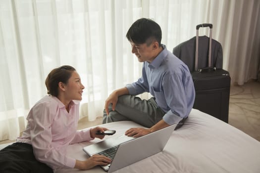 Business couple in hotel room