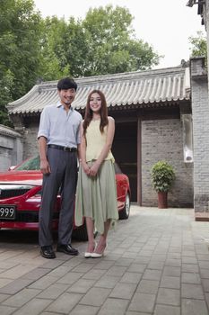 Young Couple in Front of Their Car