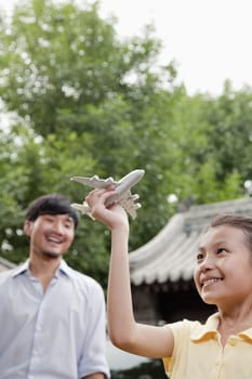 Girl Playing with Airplane