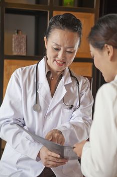 Doctor Discussing Medical Chart with Nurse
