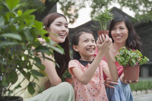 Two Women and Young Girl Gardening