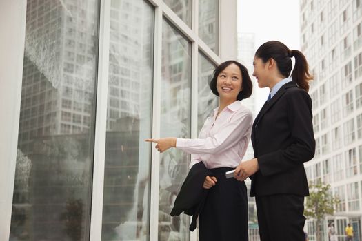 Young businesswomen walking outside of the office