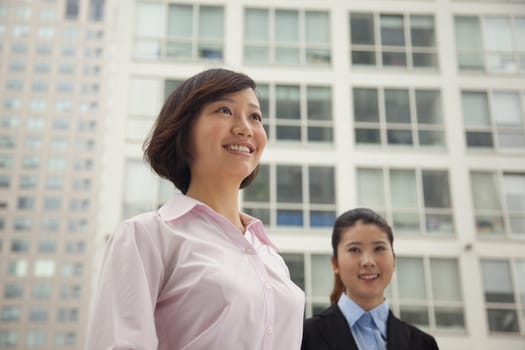 Young business women standing outside of CBD, portrait