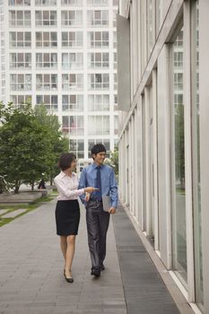 Businessman and businesswomen walking out side of CBD