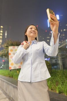 Young businesswoman taking a picture of her self with her cell phone