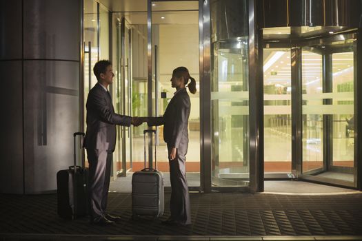 Young business people handshaking outside of the office